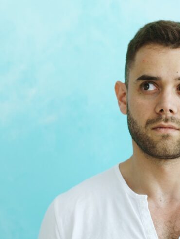 Man looking away from camera on blue background